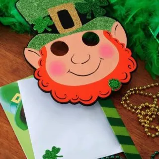 Create a fun St. Patrick's Day mask using finds from the $1 bin at the craft store - as well as some glitter and Mod Podge!