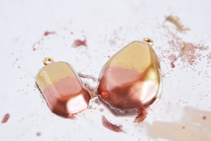 Melted copper and gold embossing powder on gem shapes