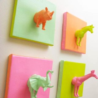 Plastic animals on mini canvases