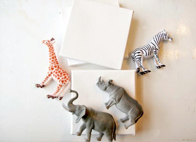 Supplies to make DIY wall art with plastic animals