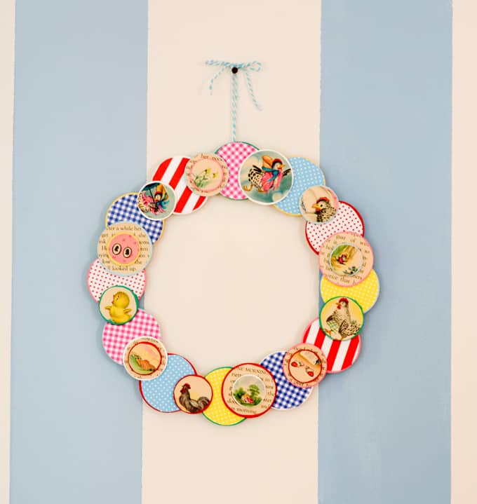 Make a simple DIY wreath for your craft room door using some of the pages from an old book, wood circles, and an embroidery hoop. So fun and colorful!
