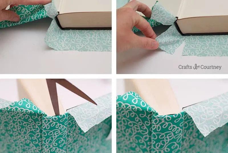Cutting slits in the fabric with scissors to fit the spine of the book