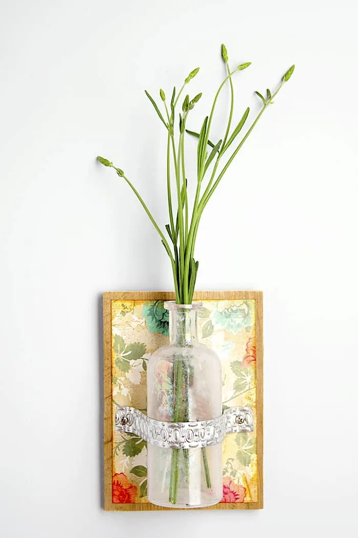 Display fresh flowers and herbs in your home this summer with an easy-to-make wall vase using a recycled bottle.