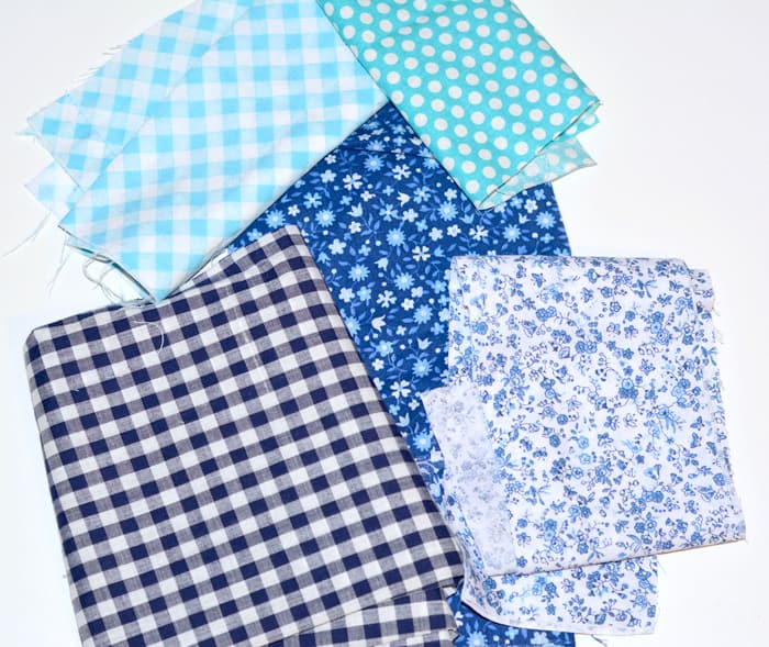 Piles of blue fabrics in various patterns