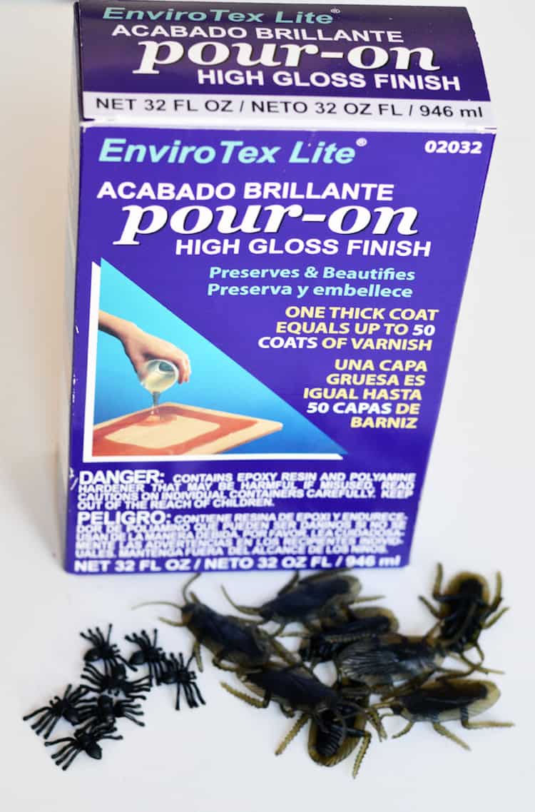 Box of Envirotex Lite resin with fake plastic roaches and spiders