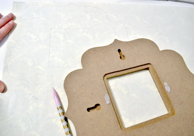Trace the frame on the back of the scrapbook paper with a pencil