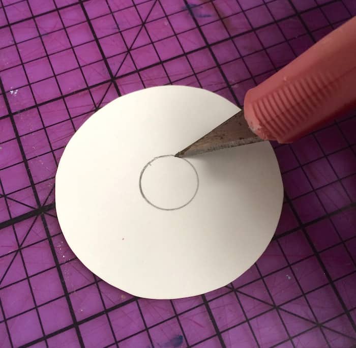 Cut out the center of the scrapbook paper with a craft knife