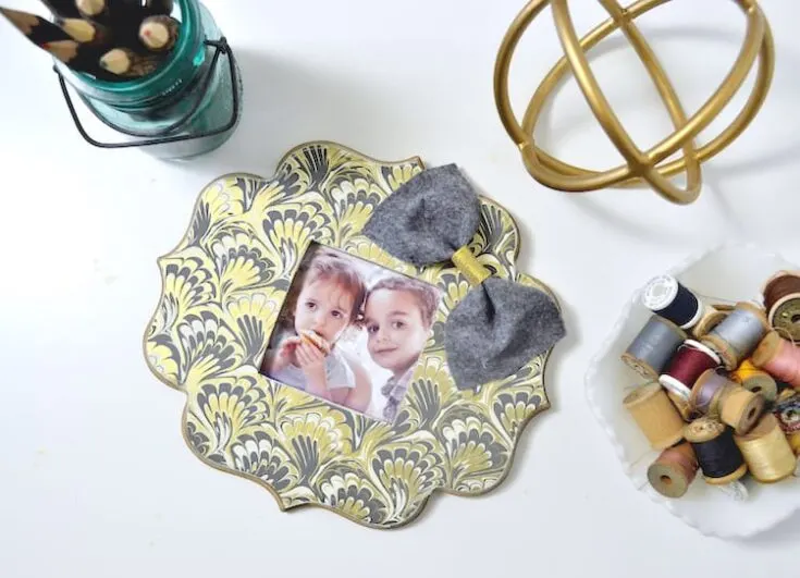 If you've ever found a beautiful piece of paper begging to be used in a craft, this DIY photo frame is perfect - so easy to make with Mod Podge!