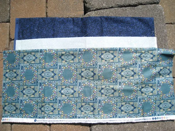 Blue fabric, white fabric, and blue green patterned fabric
