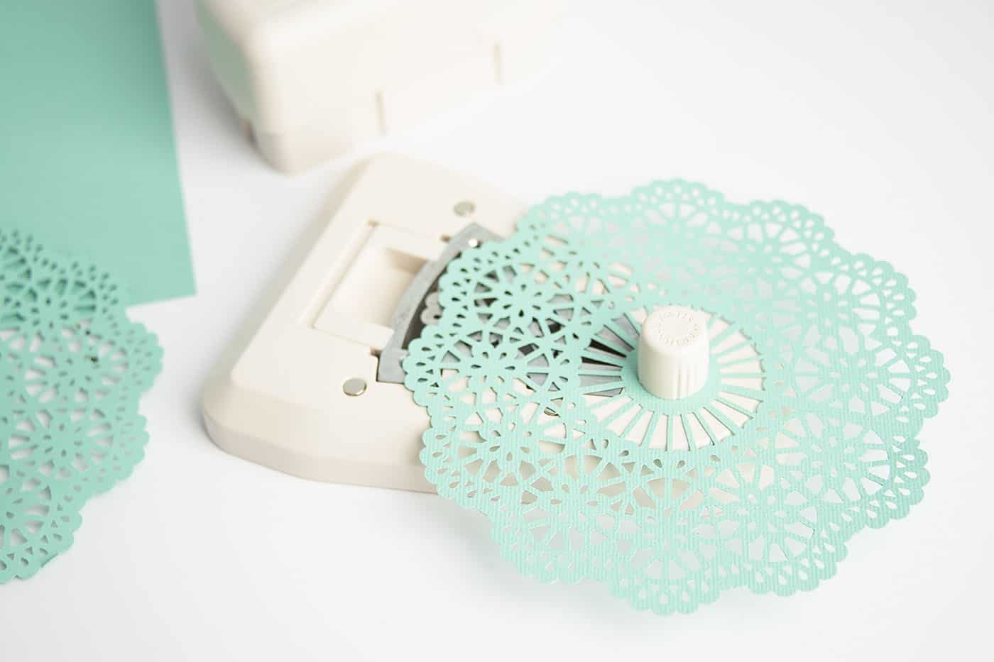 Cutting paper with a doily punch from scrapbook paper