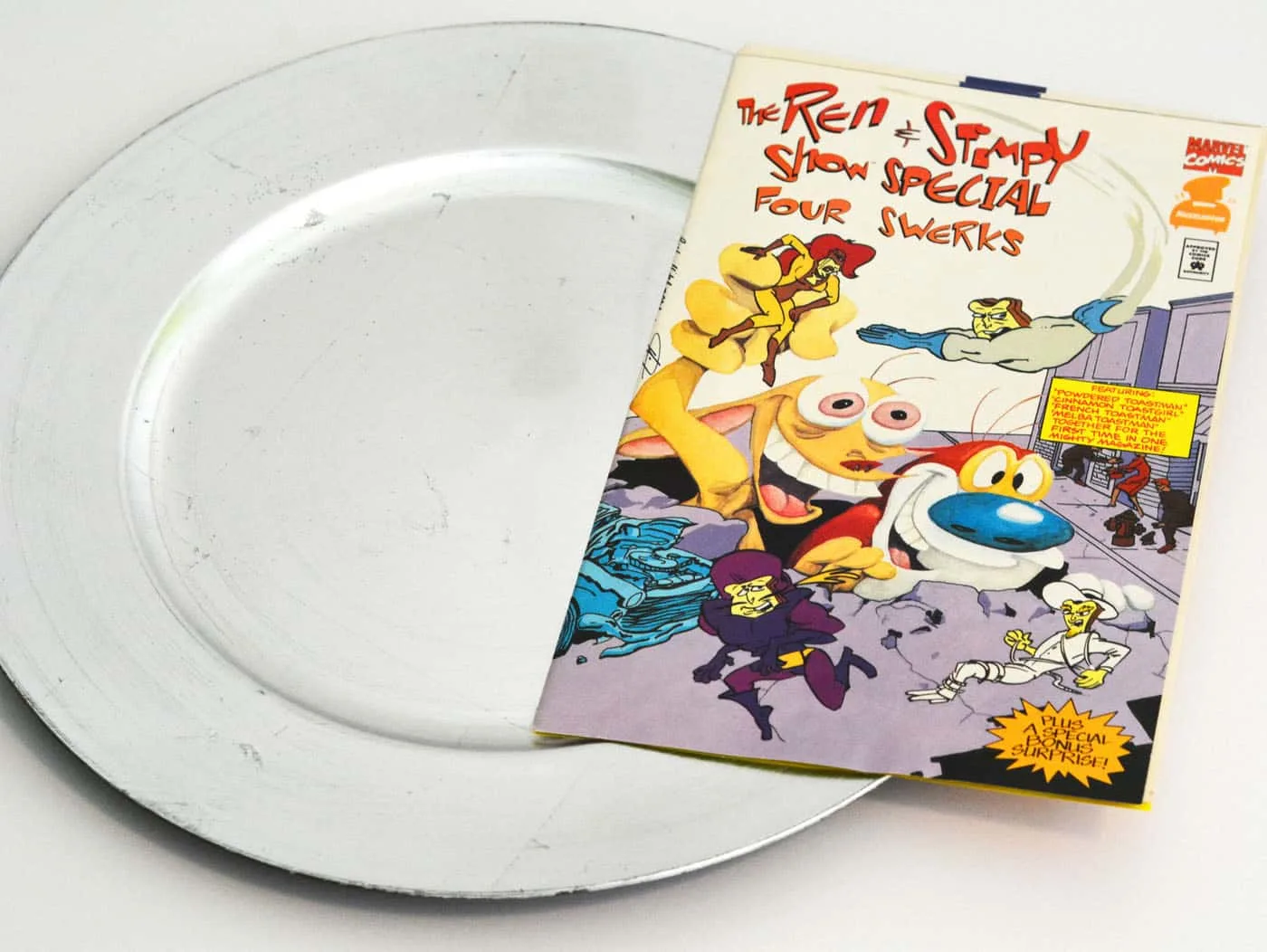 Charger plate and a Ren & Stimpy comic book
