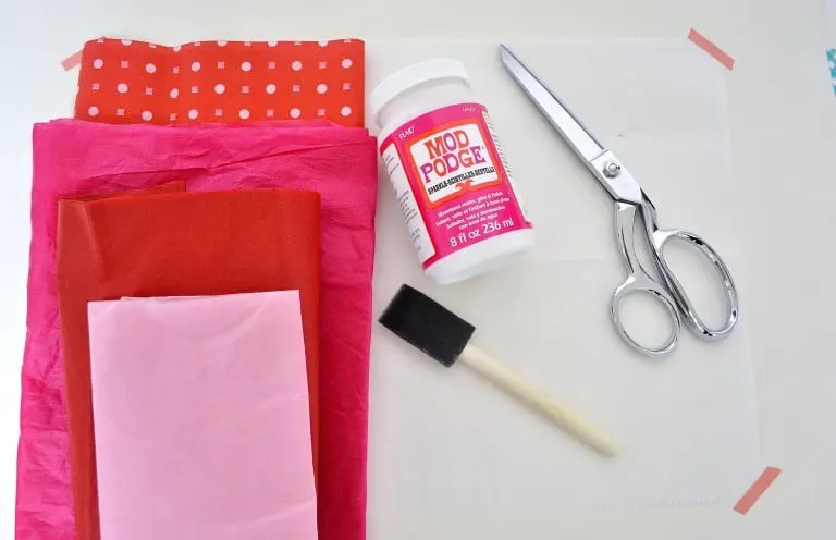 Tissue paper, Mod Podge Sparkle, silver scissors, and a foam brush