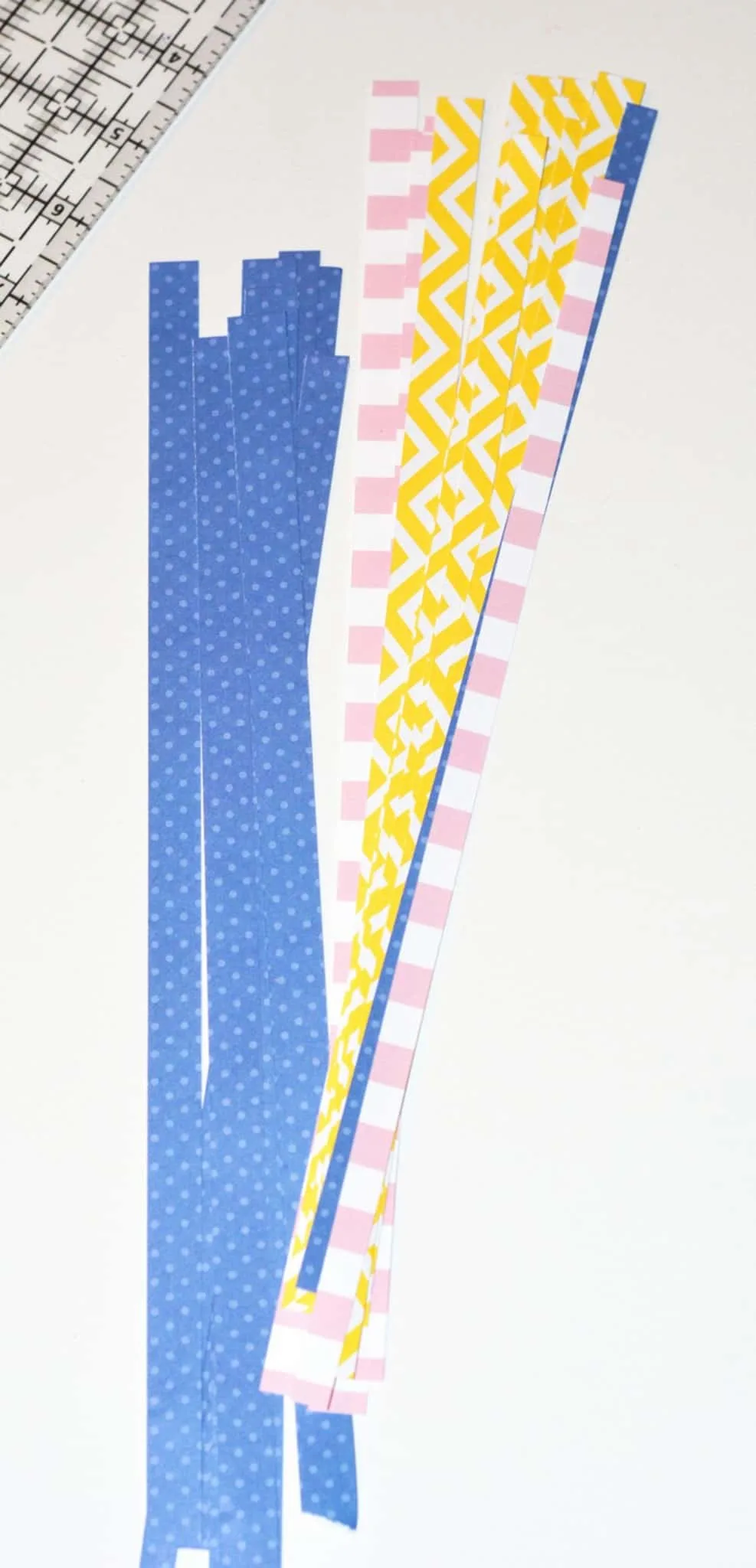Long strips of scrapbook paper in a pile