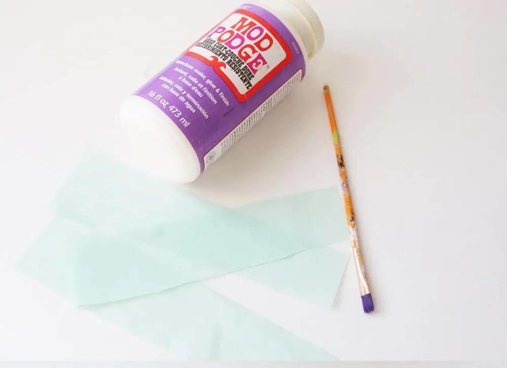 Mod Podge Hard Coat, tissue paper, and a paintbrush