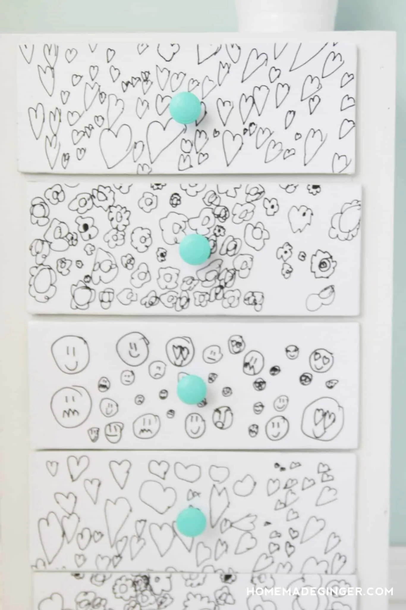 Child's drawings on the front of dresser drawers