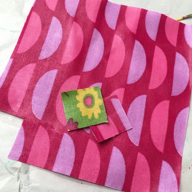 Cutting fabric that has been Mod Podged into small squares