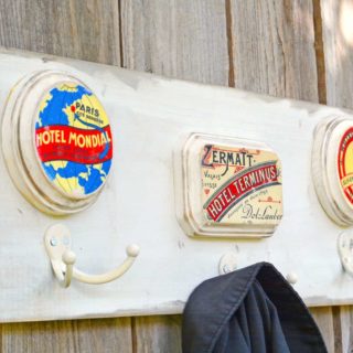 Learn to make a wooden coat rack from a plank and some small plaques. Add vintage travel themed graphics with Mod Podge photo transfer medium!