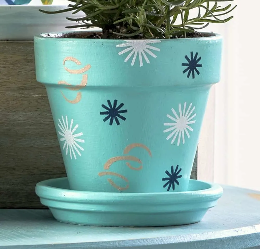 Clay pot decorating with adhesive stencils