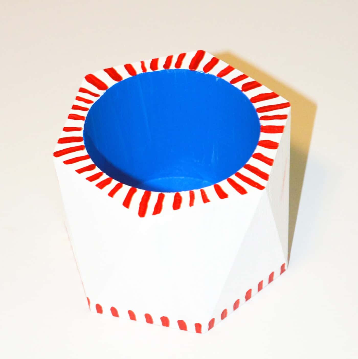 Wooden pencil cup painted on the inside with blue and outside with white