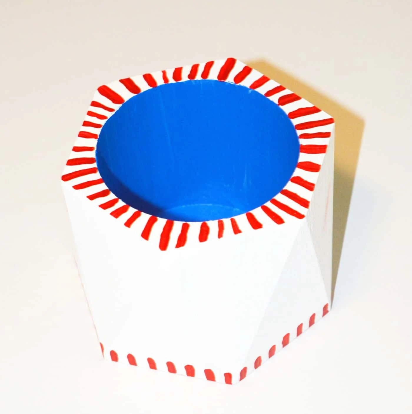 Wooden pencil cup painted on the inside with blue and outside with white