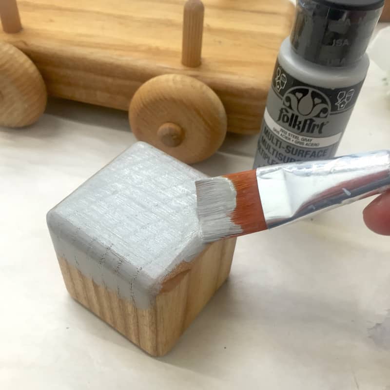 Painting a wood block with gray craft paint