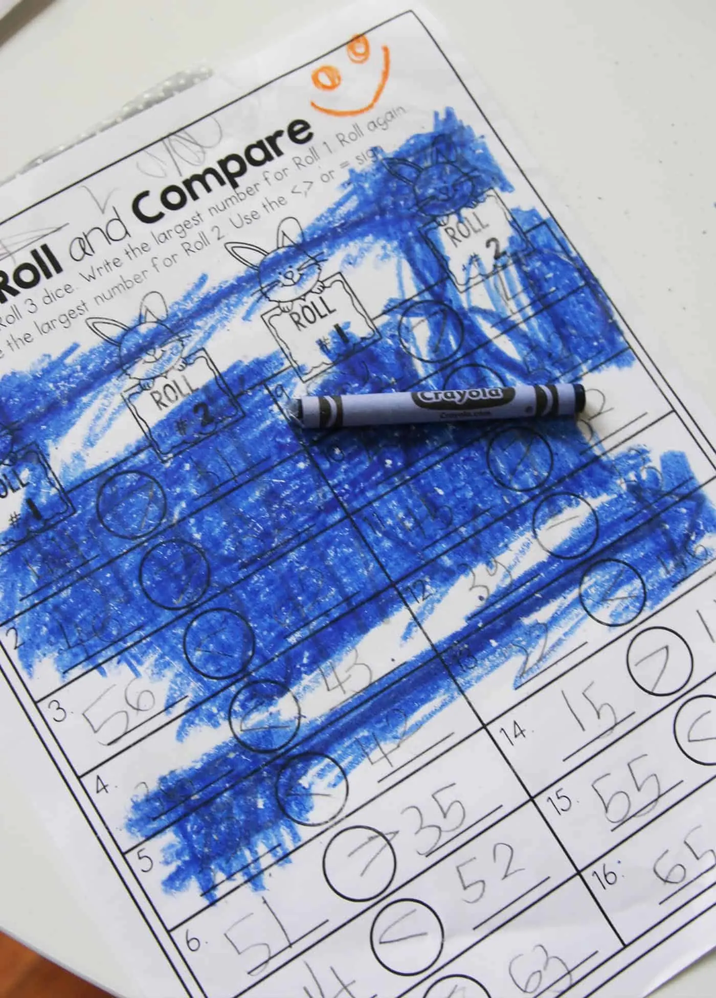 Coloring on a worksheet with blue crayon