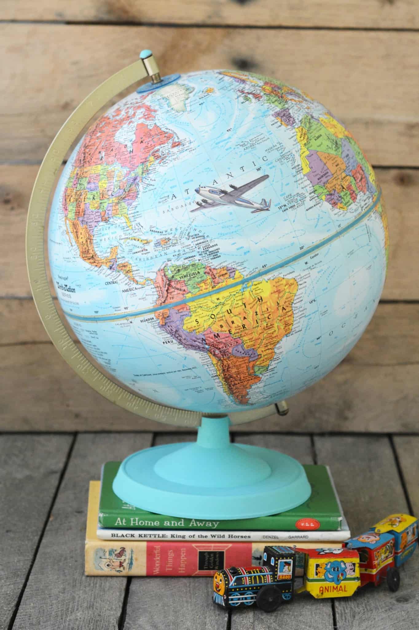 Learn how to customize a vintage globe with your favorite images from children's books - this is such a unique home decor project!