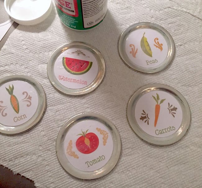 Drying mason jar lids with the labels attached with Mod Podge