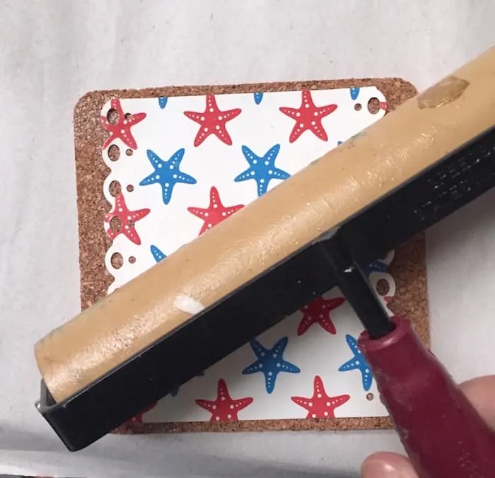 Smoothing the paper down with a brayer