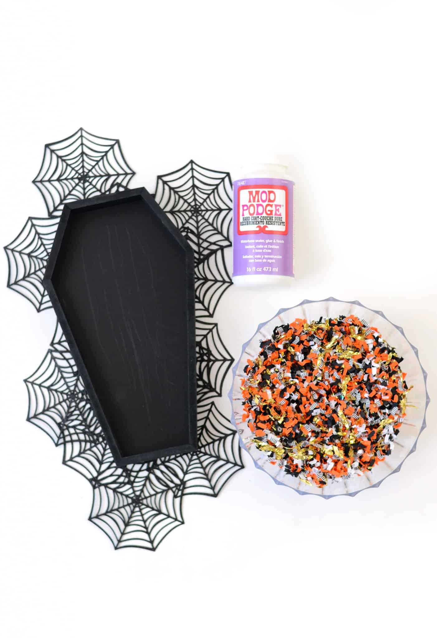 Black wood coffin tray, Mod Podge, and Halloween confetti