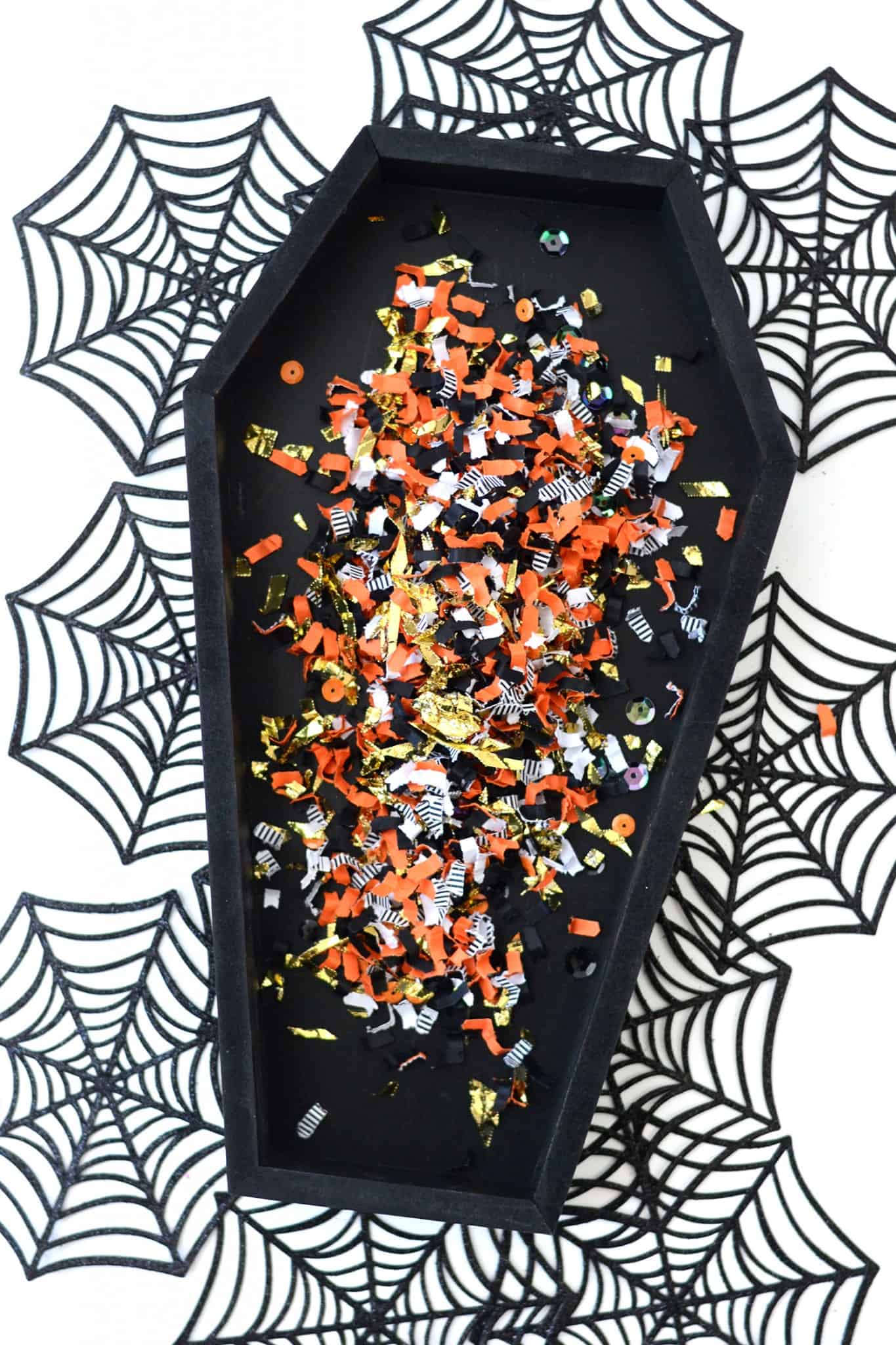 Black wood coffin sprinkled with confetti