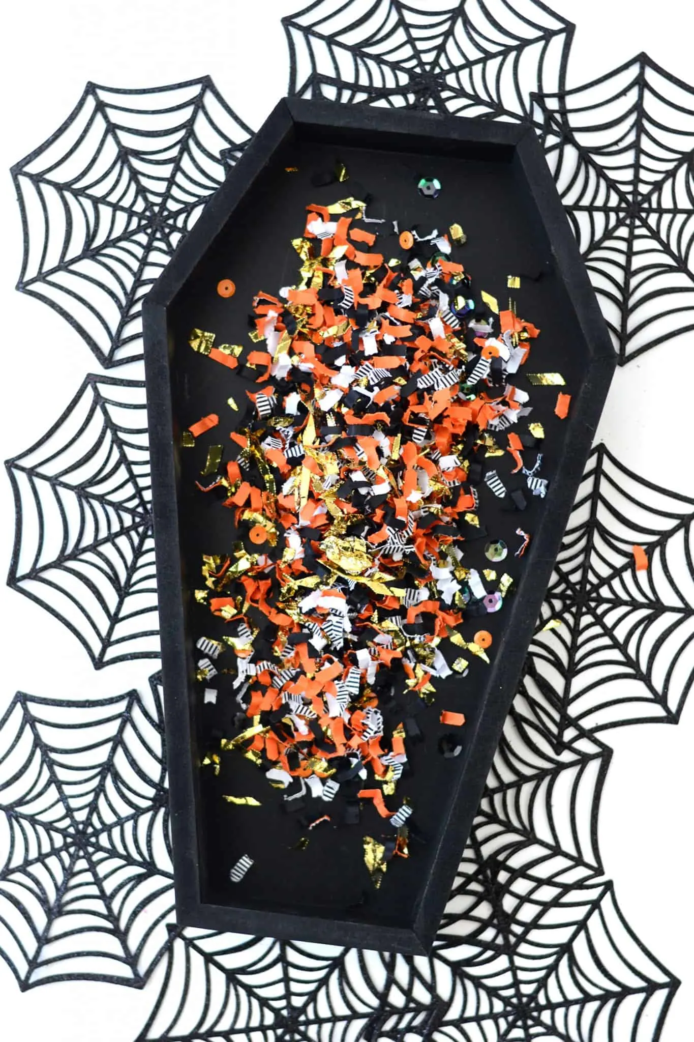 Black wood coffin sprinkled with confetti