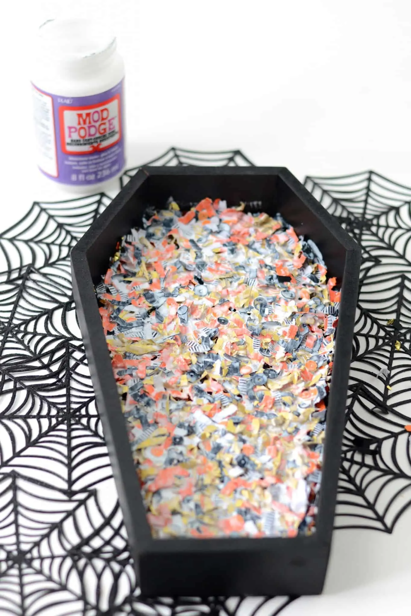 Wet Halloween confetti drying inside a wood tray