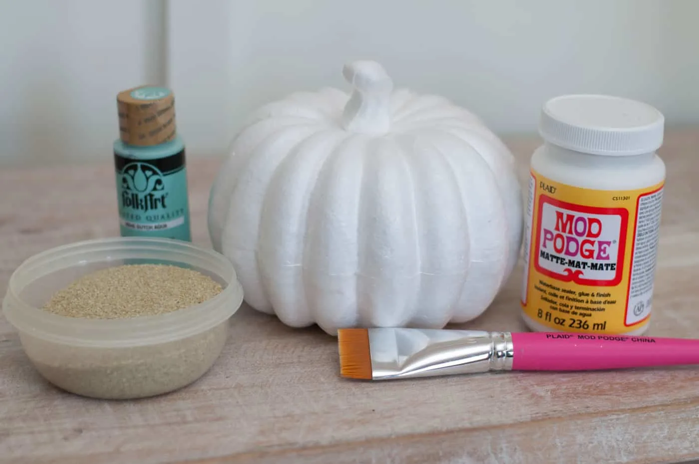 Foam pumpkin, craft paint, Mod Podge, sand, and a paintbrush