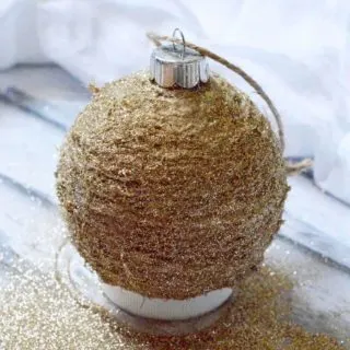 Glitter drying on the twine Christmas ornament