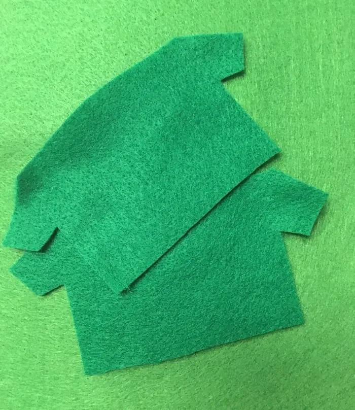 Two pieces of green felt cut into elf shirts