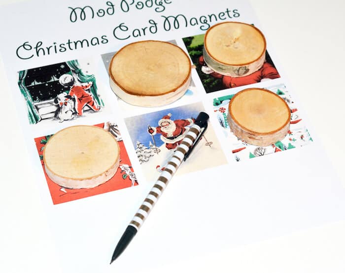 Wood slices on top of the vintage Christmas printable with a pencil