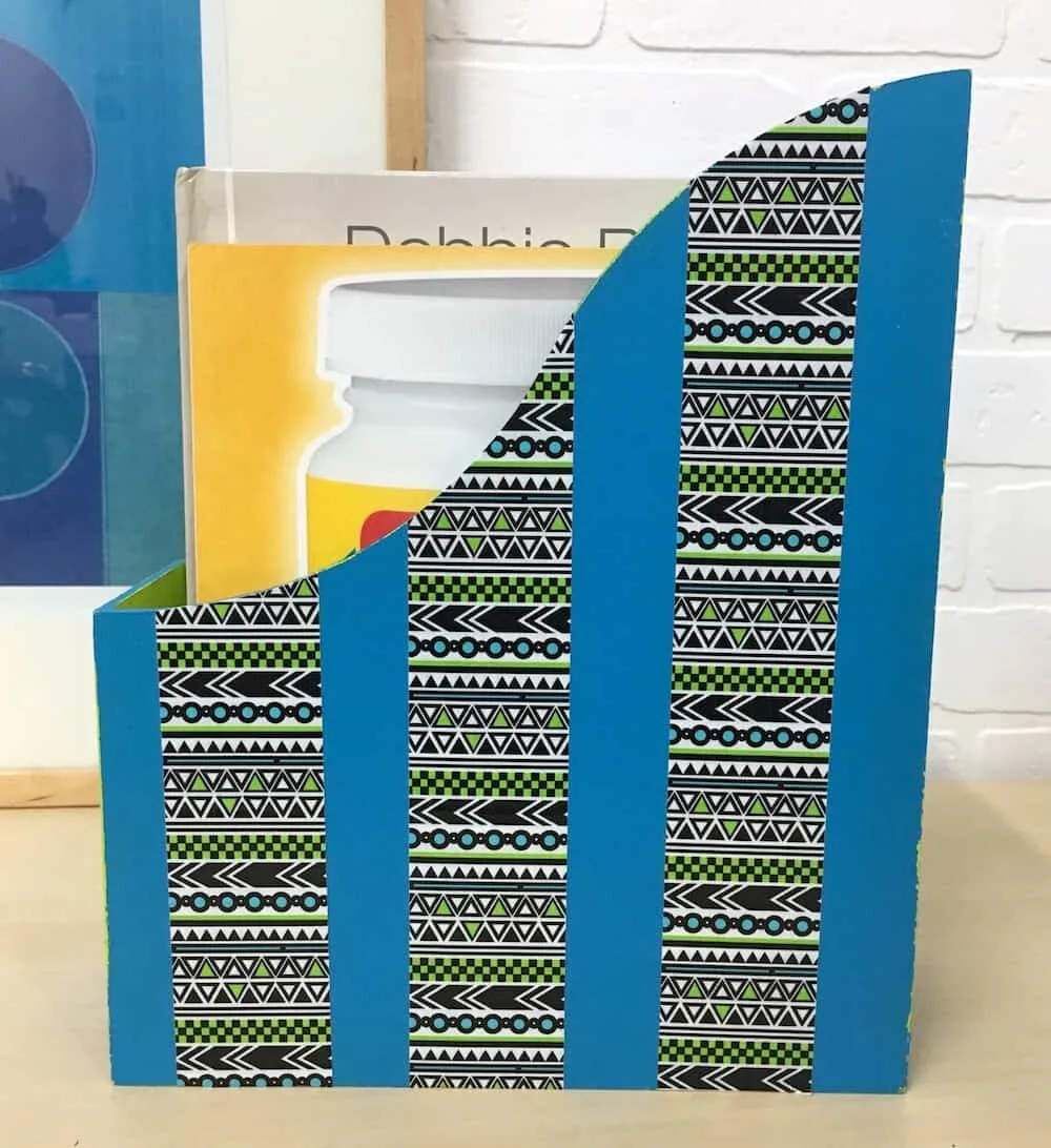 Blue DIY magazine holder with tribal Duck Tape on the sides