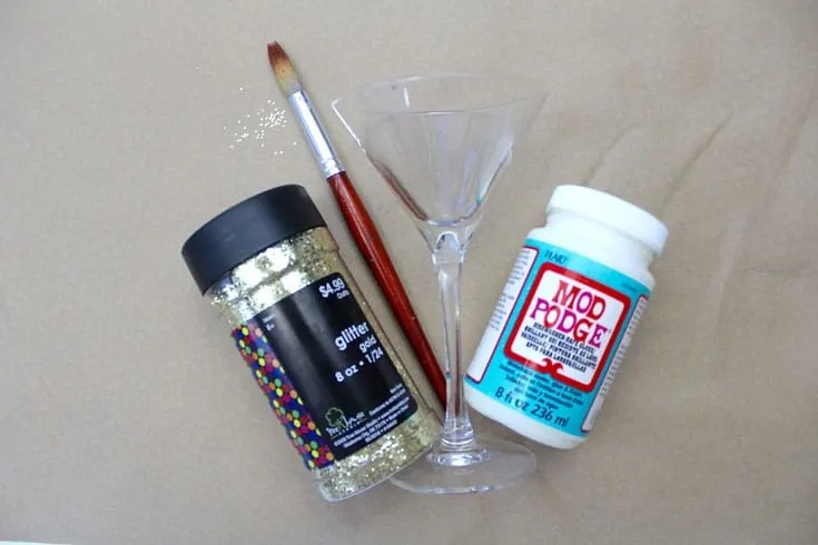 Glitter, paintbrush, martini glass, and Dishwasher Safe Mod Podge