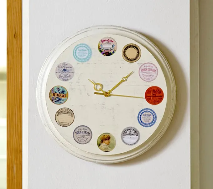 This DIY wall clock is easy to make, using vintage inspired labels and Mod Podge. Follow this tutorial and create your own version!