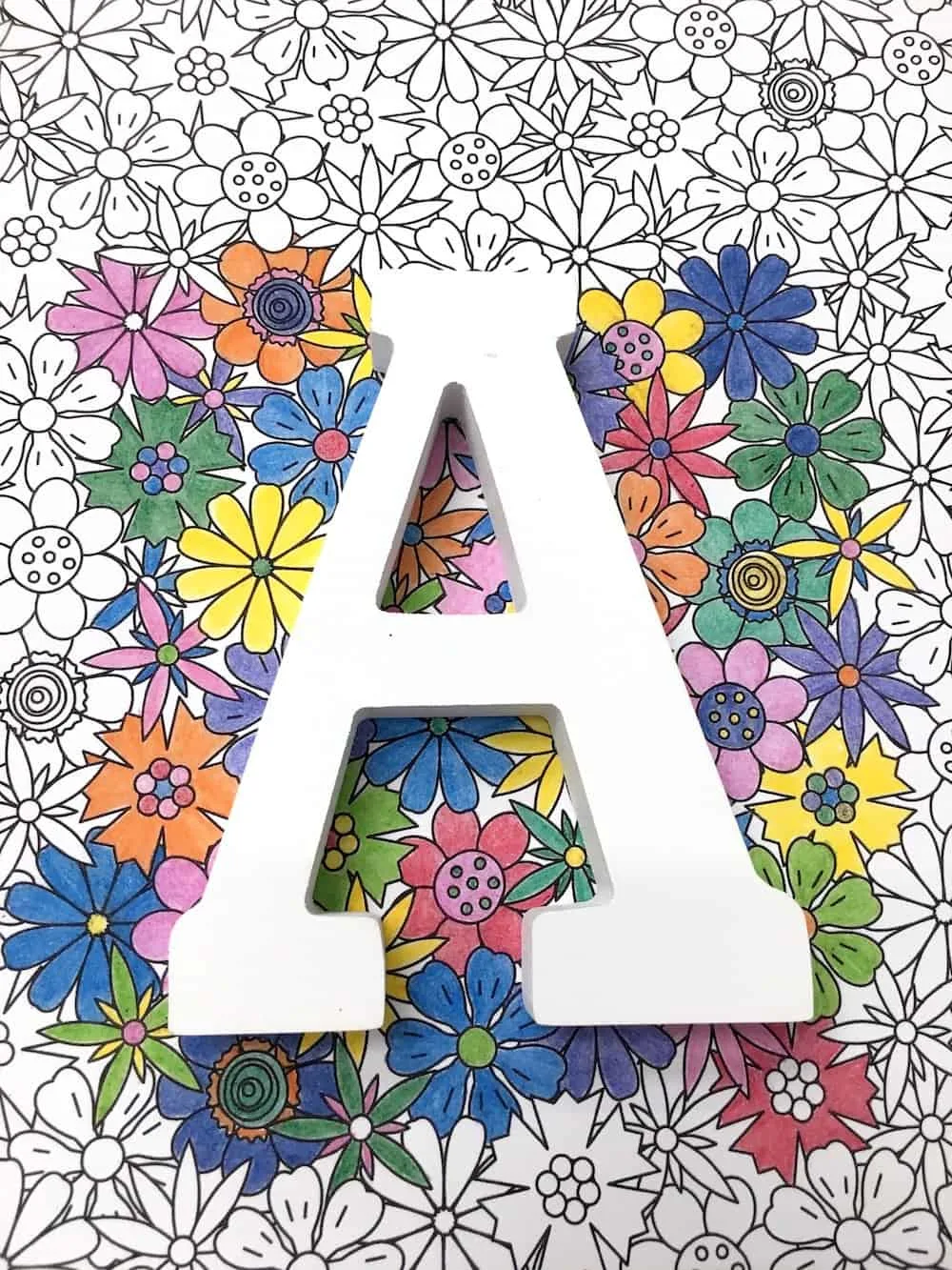 White wood letter A placed over the top of the coloring page