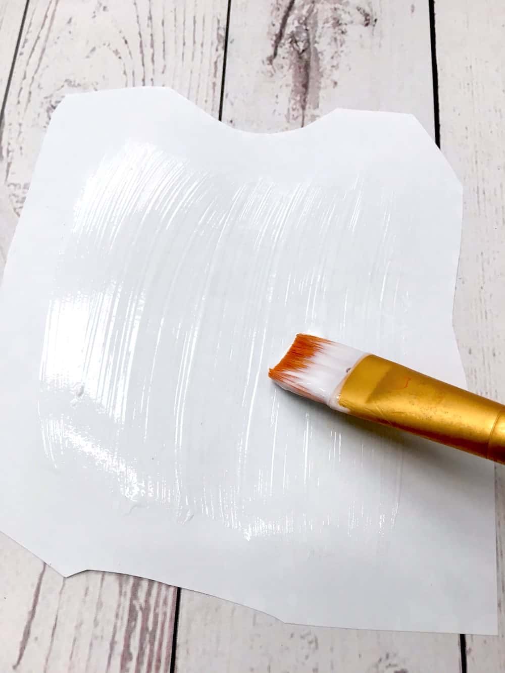 Applying Hard Coat to the back of a coloring page with a brush