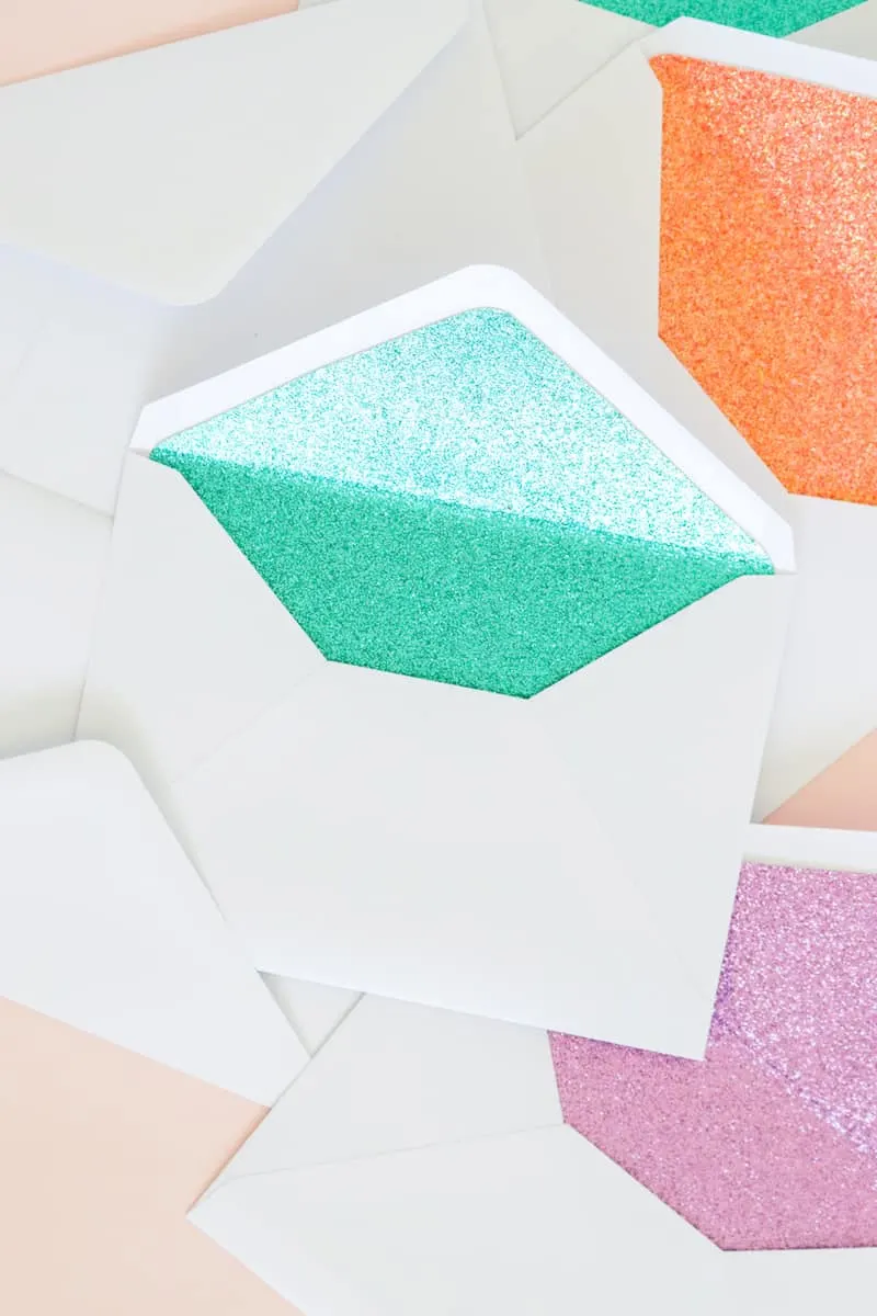 These DIY glitter lined envelopes are easy to make and add a surprise pop of color when the envelope is opened! Perfect for party invitations.
