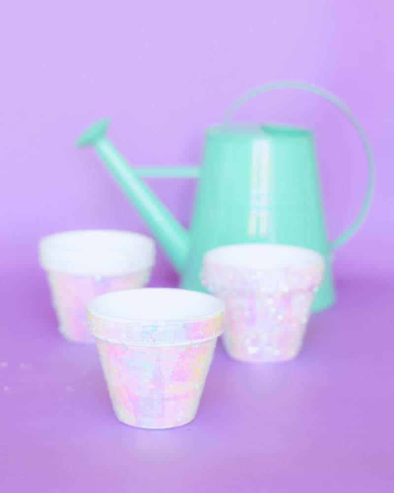These terracotta plant pots are unicorn inspired, with iridescent cello wrap applied with Mod Podge and confetti. Perfect for parties!