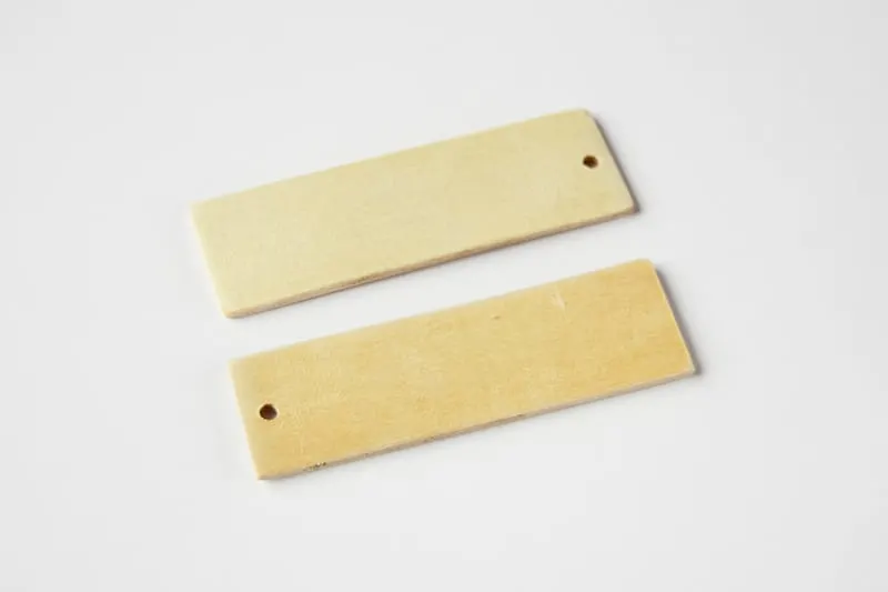 Two wood pieces with holes drilled in one end