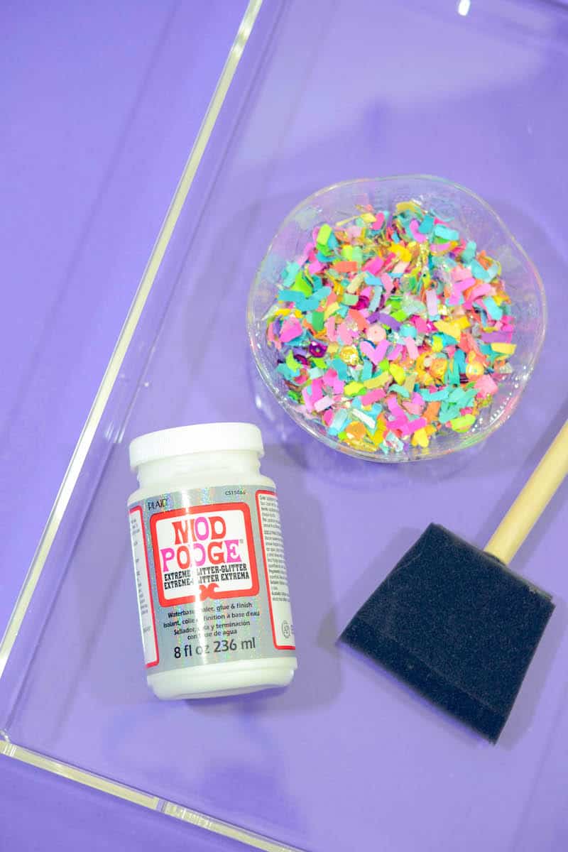 Clear acrylic tray, Mod Podge extreme glitter, foam brush, and colorful confetti