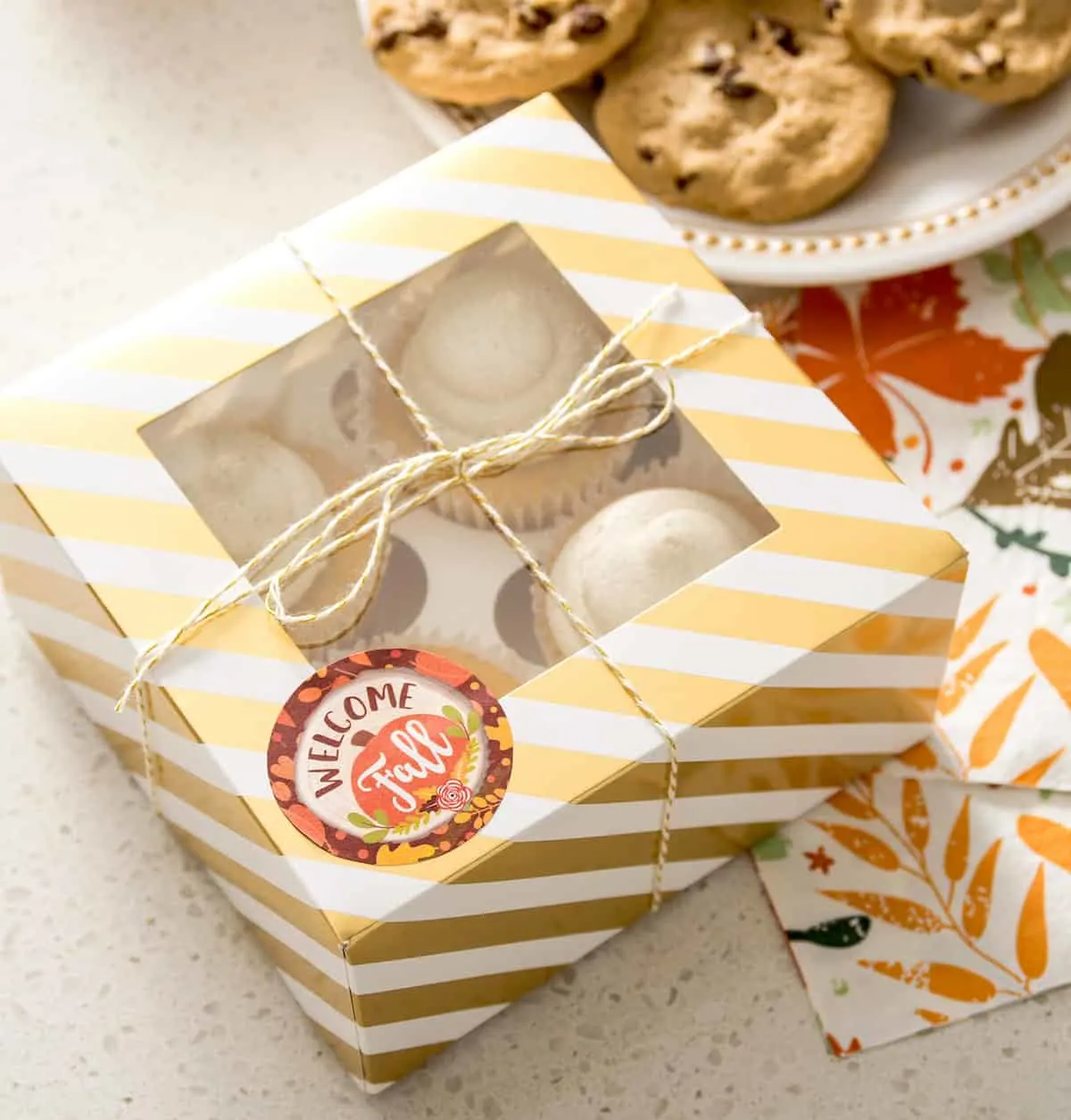 Cupcakes wrapped in a box with baker's twine and a sticker that says Welcome Fall