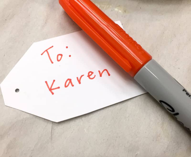 Writing on a gift tag with Sharpie