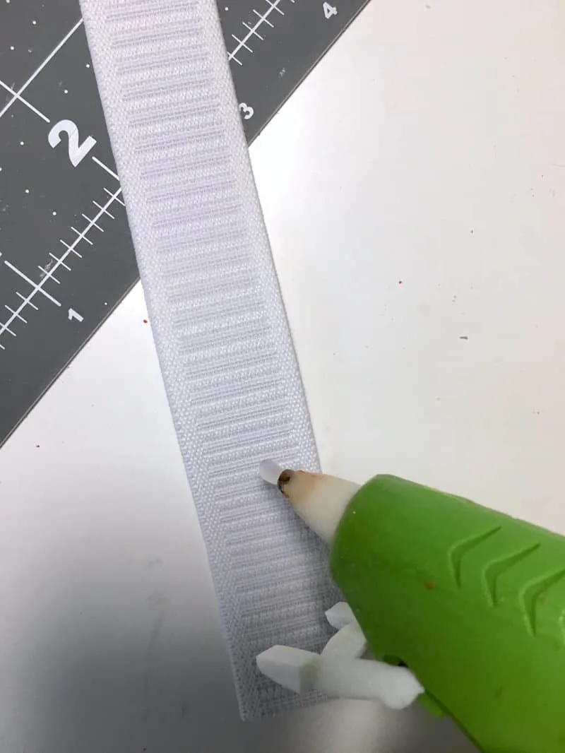 Hot gluing a piece of elastic with a hot glue gun