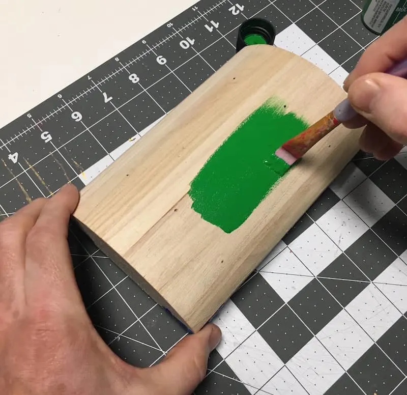 Paint a wooden treasure chest lid with green acrylic paint